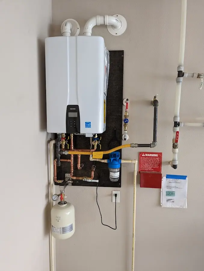 Professional plumber installing copper piping in a Ephrata home